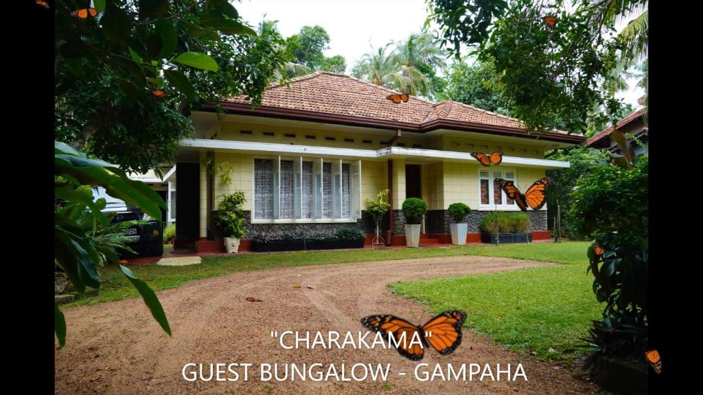 a house with butterflies in front of it at CHARAKAMA Guest Bungalow - GAMPAHA in Gampaha