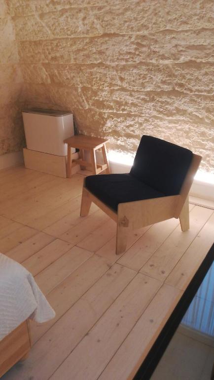 a chair sitting on a wooden floor in a room at MandorleOlio in Polignano a Mare