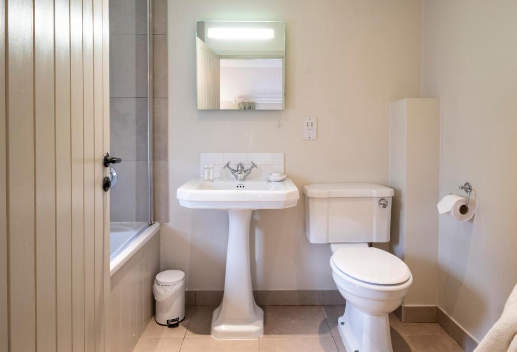 a bathroom with a white toilet and a sink at The Ship At Dunwich in Dunwich