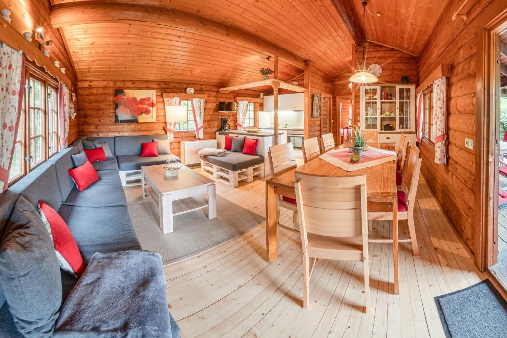 a living room and dining room of a tiny house at Glühalm Willingen in Bömighausen