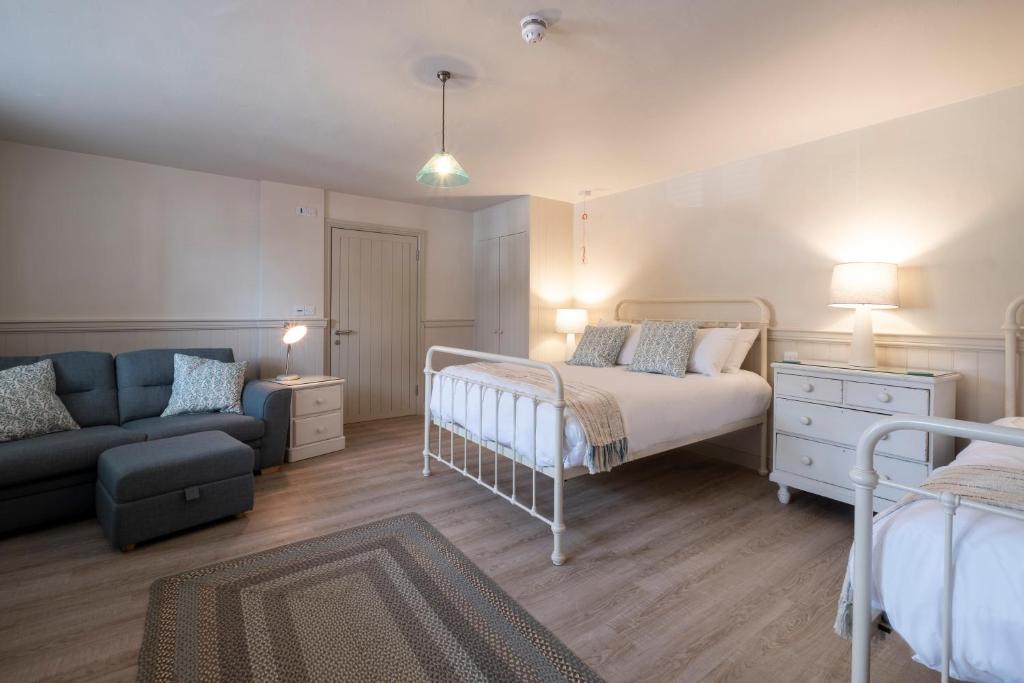a bedroom with a bed and a couch at The Ship At Dunwich in Dunwich