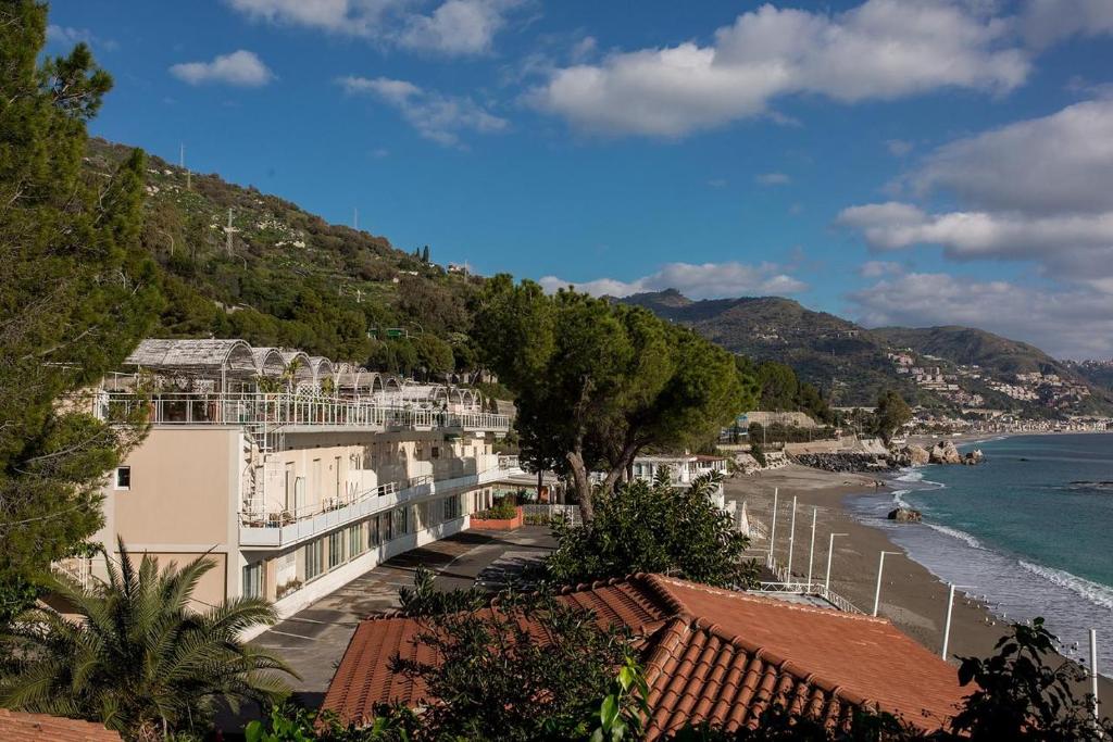a view of a beach with buildings and the ocean at Matteo's House Taormina in Taormina