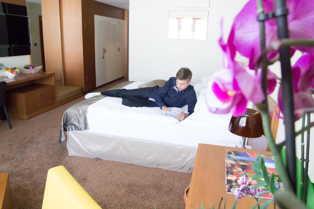 Postel nebo postele na pokoji v ubytování Mikado Hotel