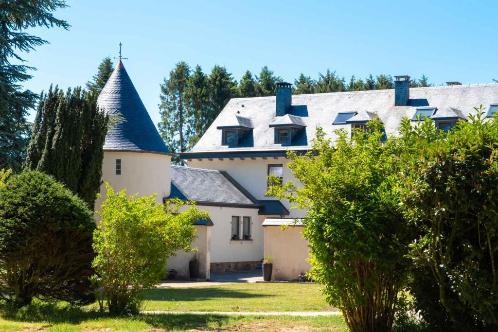 una gran casa blanca con techo azul en Le Domaine de Wisbeley, en Halet