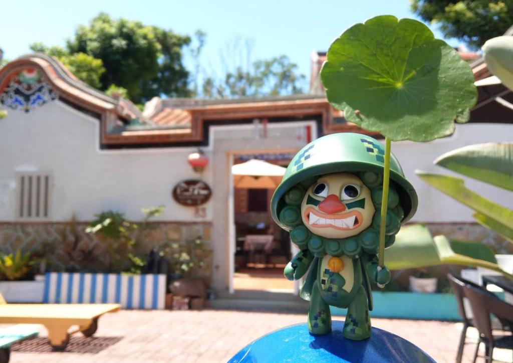a toy figure with a helmet on top of a plant at Naya"s Homestay in Jincheng