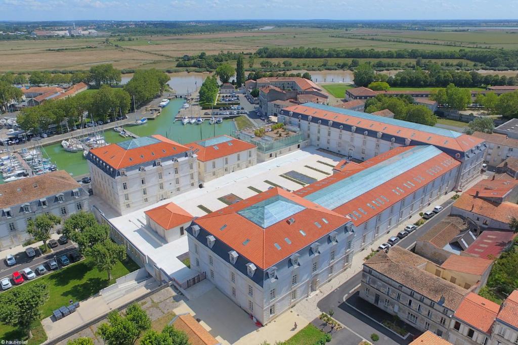 una vista aérea de un gran edificio con techos naranjas en Résidence de l'Arsenal Royal - Meublés de Tourisme en Rochefort