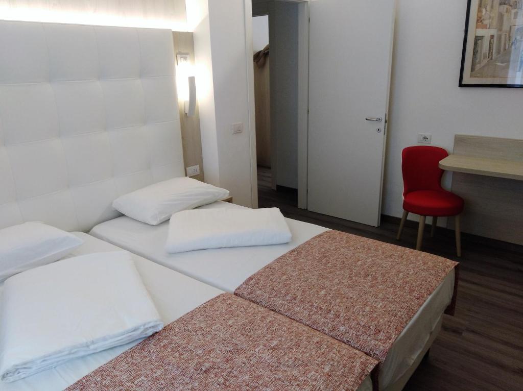 Postel nebo postele na pokoji v ubytování Hotel Orchidea