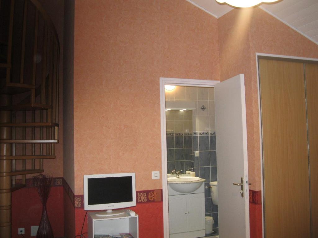 a bathroom with a computer monitor and a sink at Murmure des buis in Corveissiat