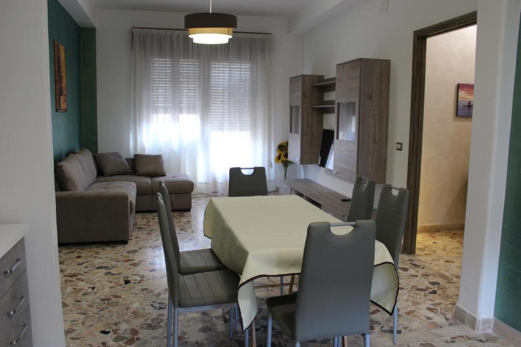 a living room with a table and chairs and a couch at Taormina Etna Sea in Piedimonte Etneo