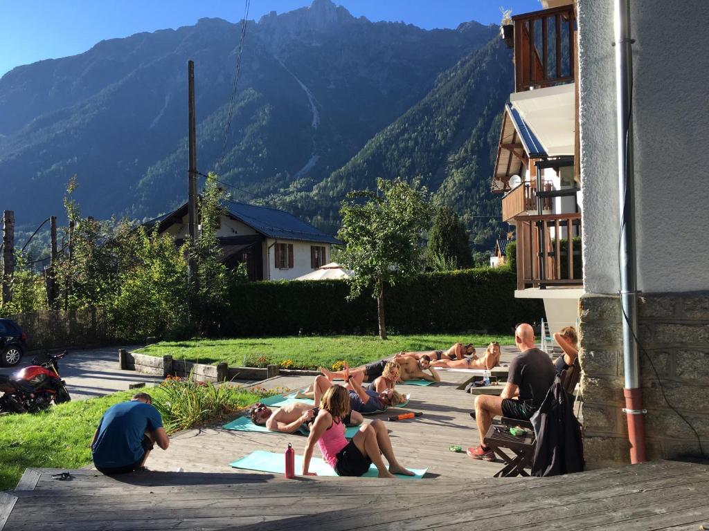 a group of people are doing yoga on the sidewalk at The Castle, 10 Bedroom Chalet, Chamonix Centre in Chamonix