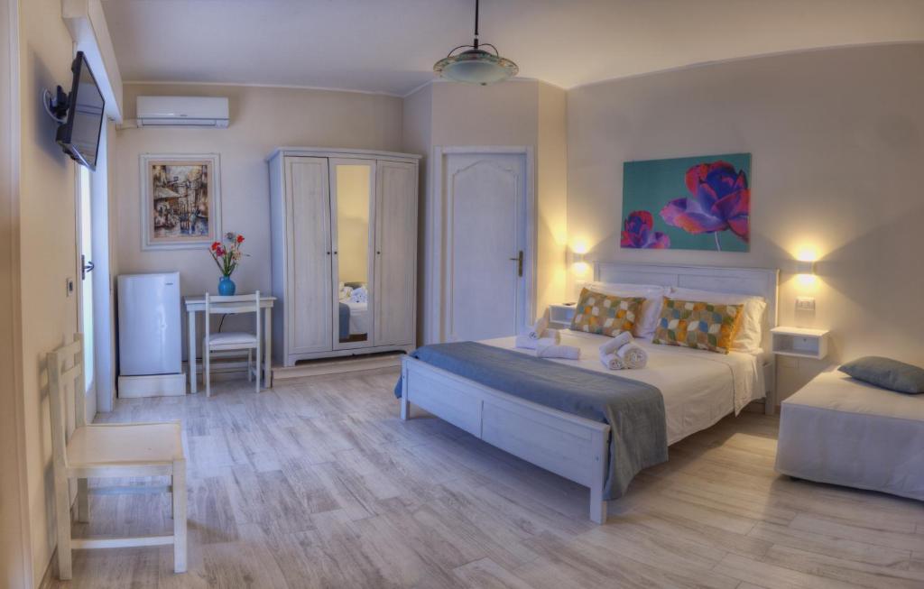 a bedroom with a bed and a table and a desk at Terra di Sole in Mazara del Vallo