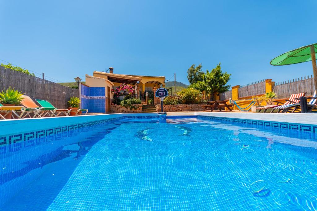 a large swimming pool with a clear blue water at Cubo's Casa Rural Villa Los Mellizos in Ardales