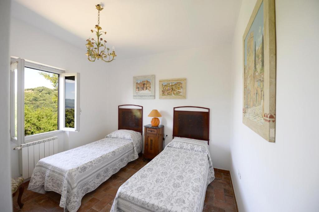 Postel nebo postele na pokoji v ubytování Casa Vacanze Podere Ugolini