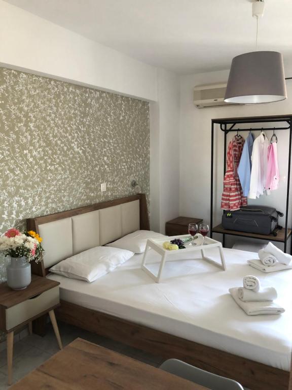 a bedroom with a large white bed in a room at Armonia Guest House Skiathos C in Skiathos