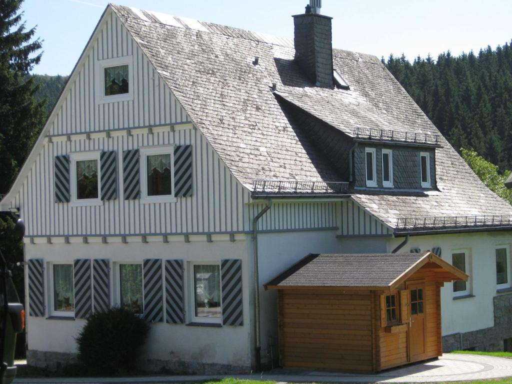 a large white house with a gambrel roof at Holiday home in Brilon near the ski slopes in Brilon