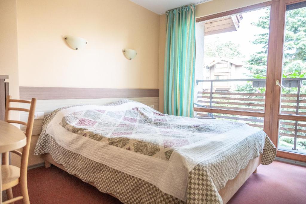 a bedroom with a bed and a large window at Nerija in Nida