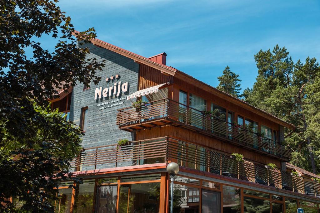 a building with a balcony on the side of it at Nerija in Nida