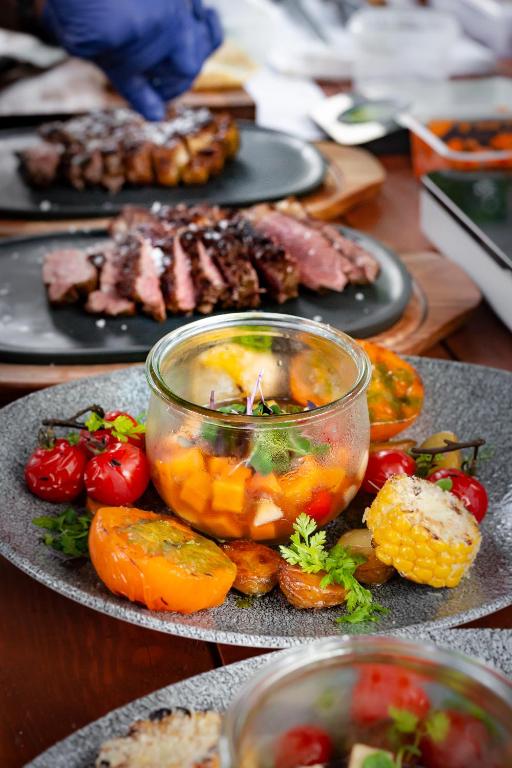 a plate of food with vegetables and meat on a table at Nerija in Nida