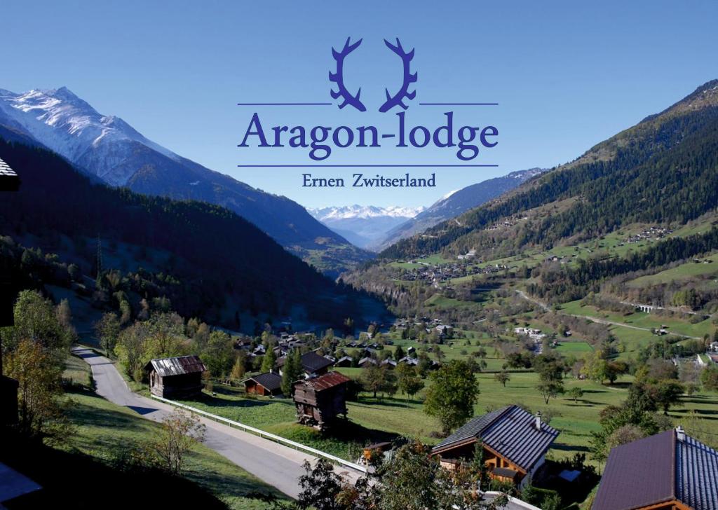a valley in the mountains with the alazon lodge at Aragon lodge in Ernen