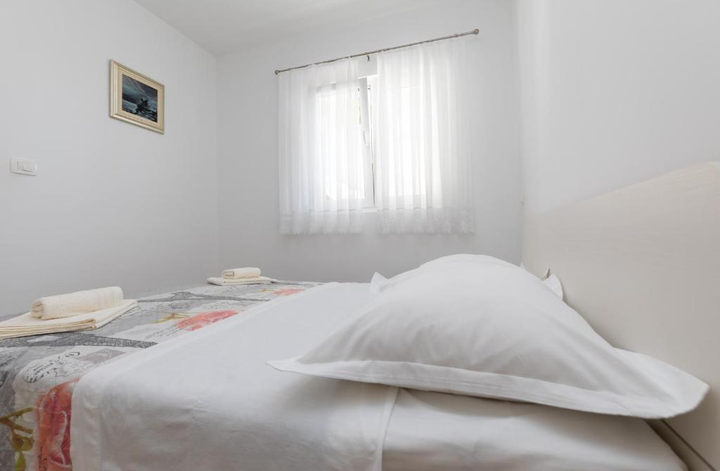 Postel nebo postele na pokoji v ubytování Apartmani Perak