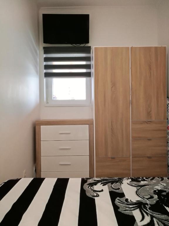 Postel nebo postele na pokoji v ubytování Roberto Apartment