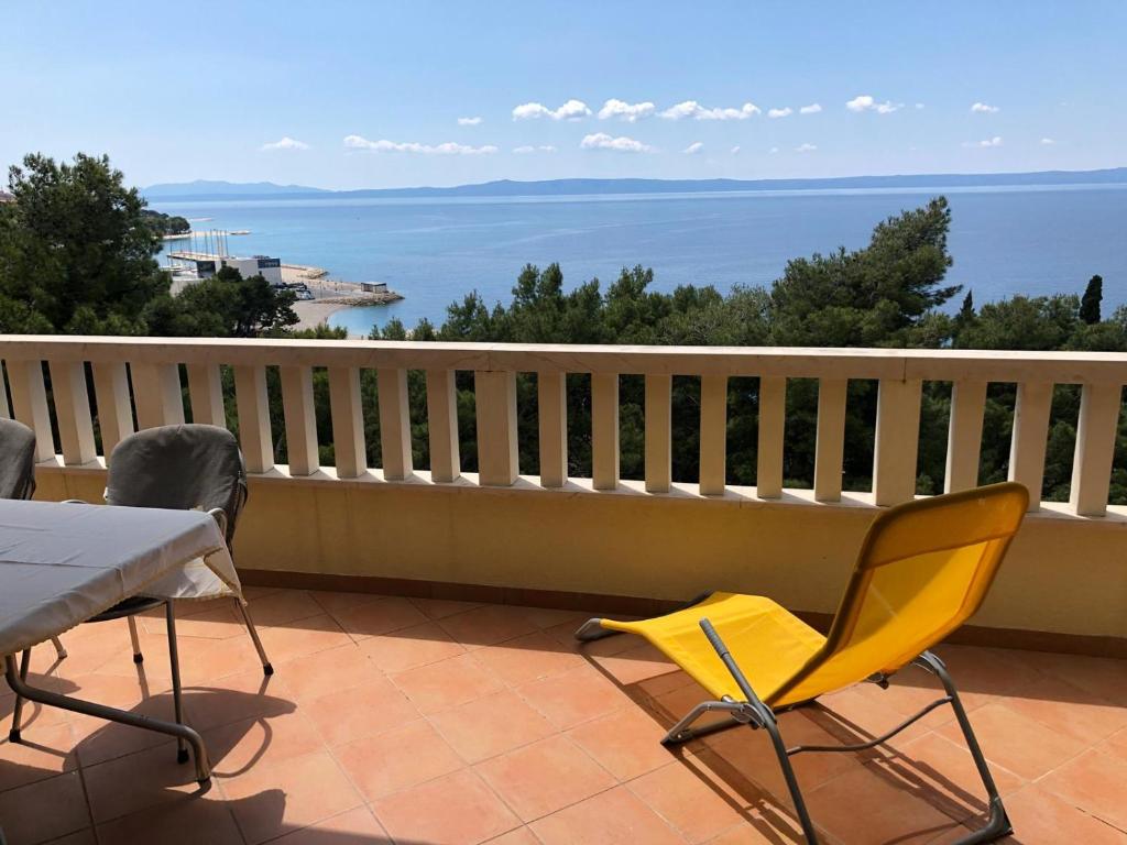 a balcony with a table and chairs and the ocean at Villa Rosso in Baška Voda