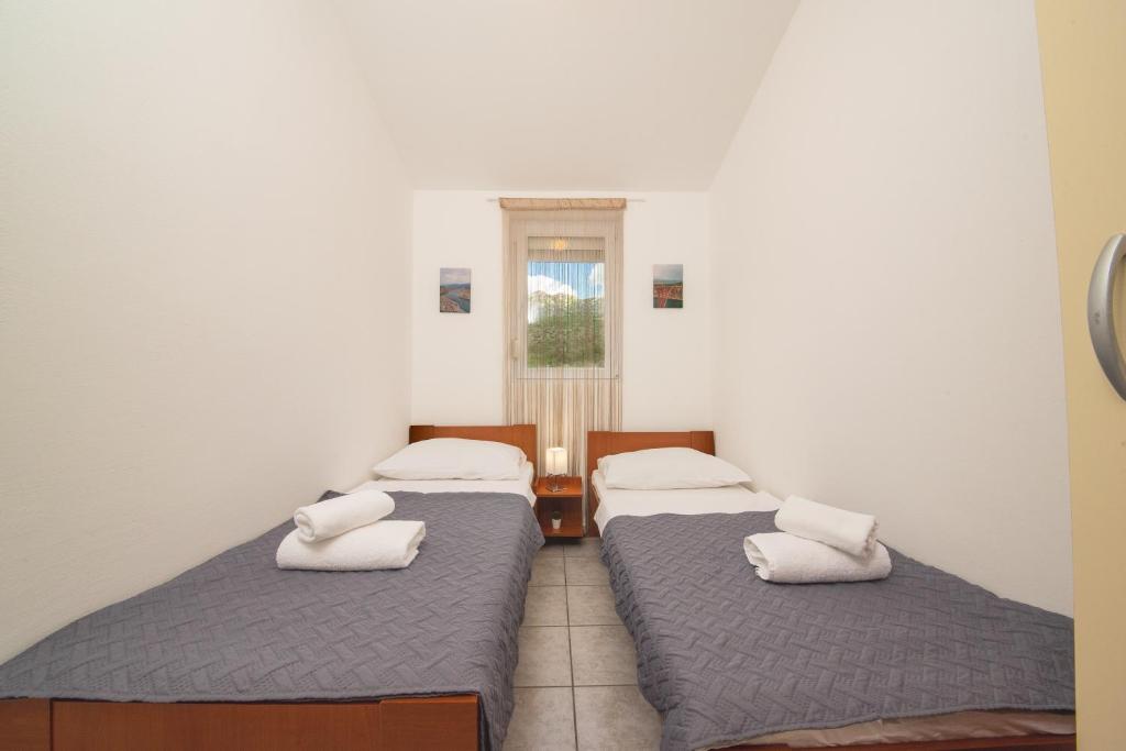 Postel nebo postele na pokoji v ubytování Apartmani Manita Paklenica