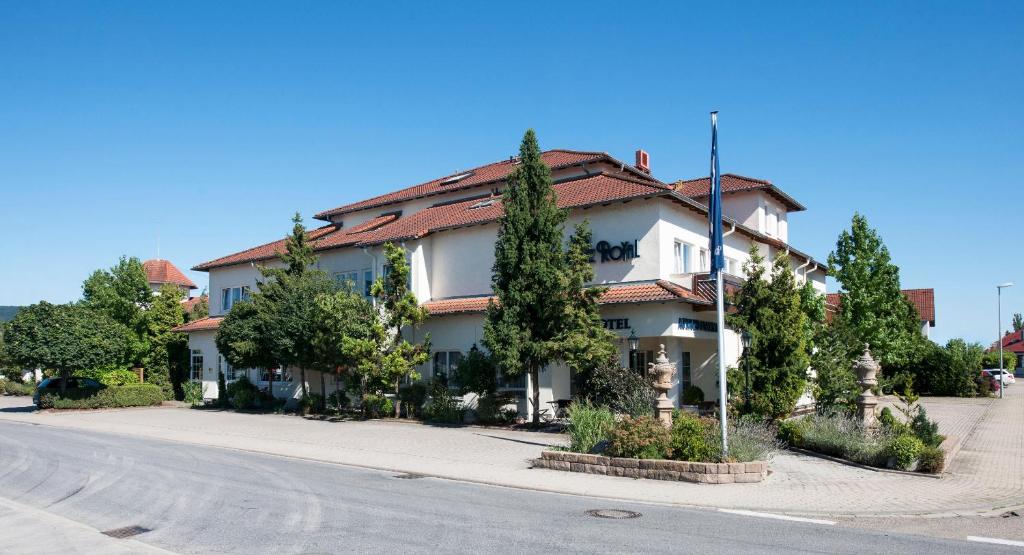 a house on the side of a street with trees at Residenz Royal in Sandhausen