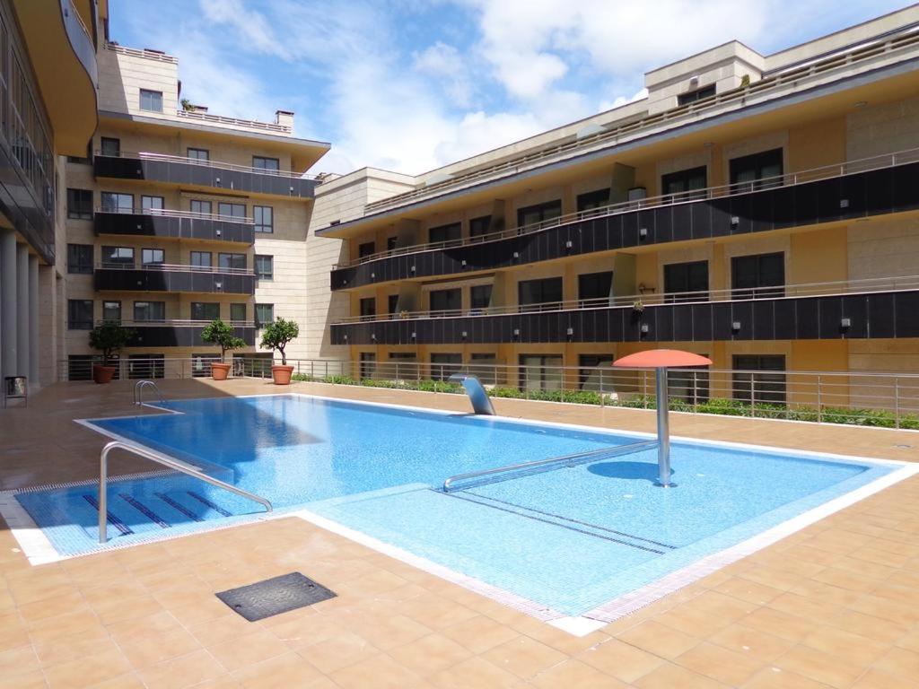 an empty swimming pool in front of a building at Playa Sanxenxo in Sanxenxo