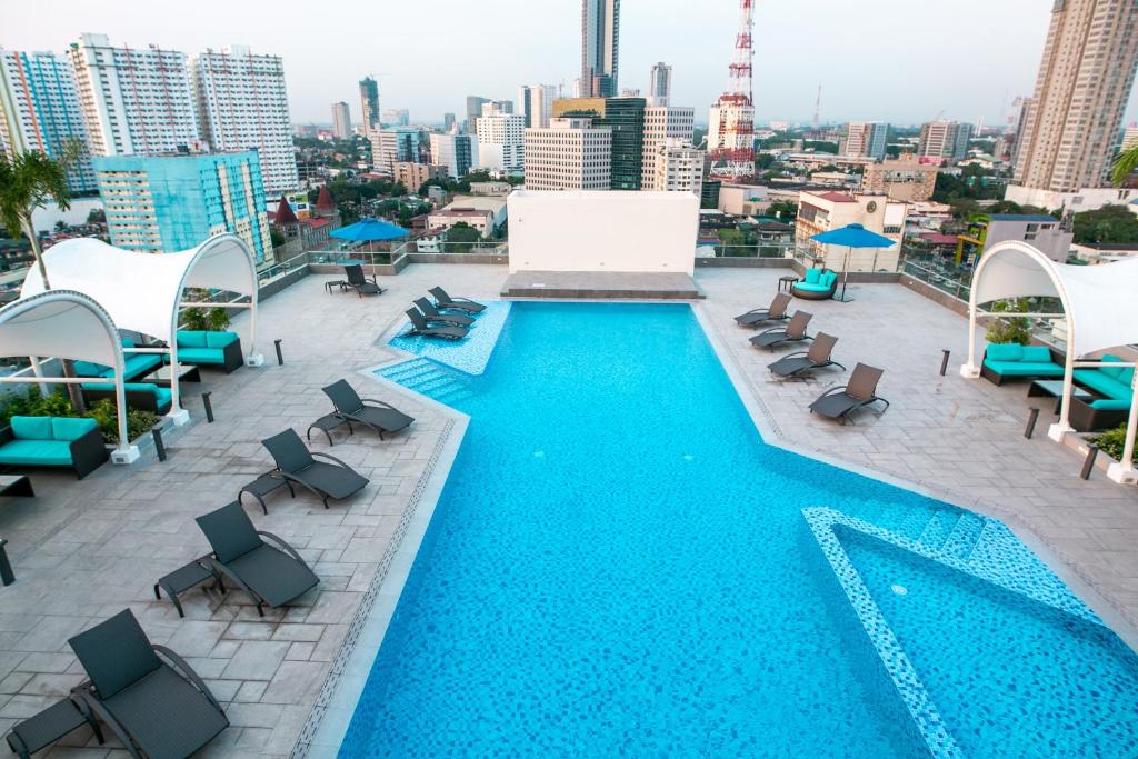 una piscina sul tetto di un edificio di Luxent Hotel a Manila