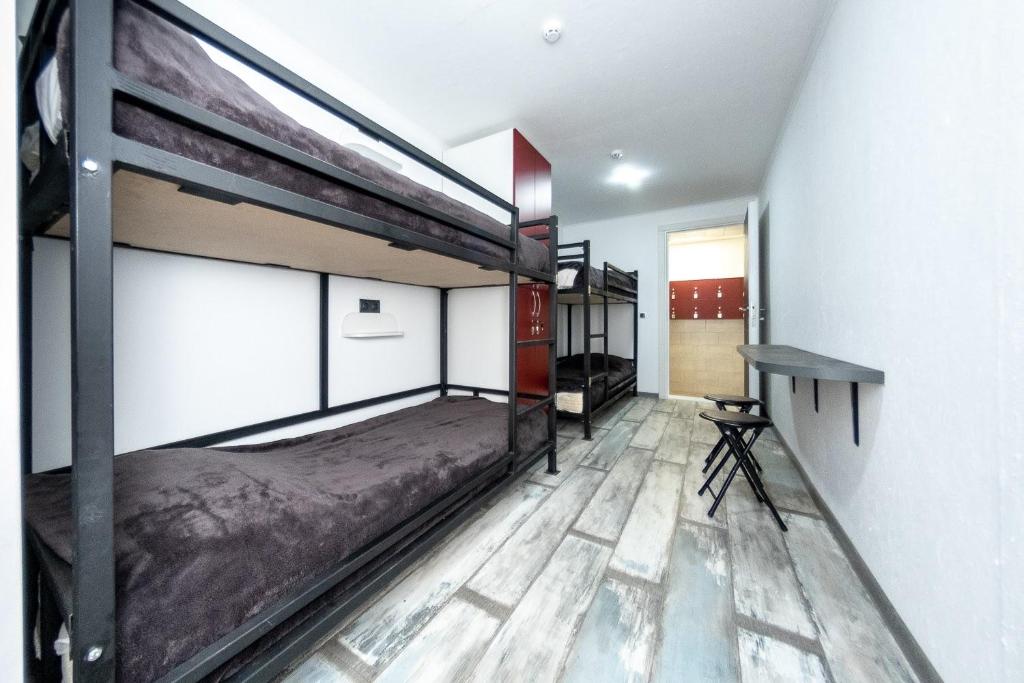 a bedroom with two bunk beds and a desk at ПИРС in Odesa