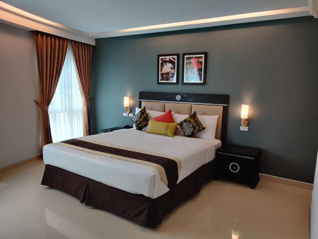 a bedroom with a large bed and a window at Club Mahindra Mac Boutique Hotel in Bangkok