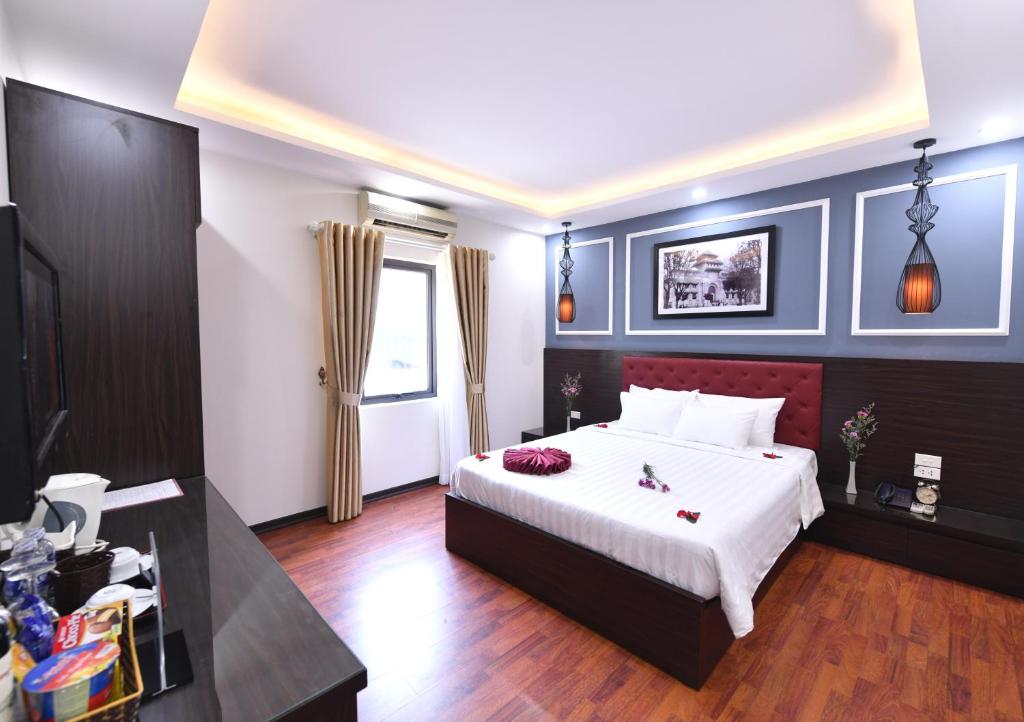Postel nebo postele na pokoji v ubytování Hanoi Elpis Grand Hotel