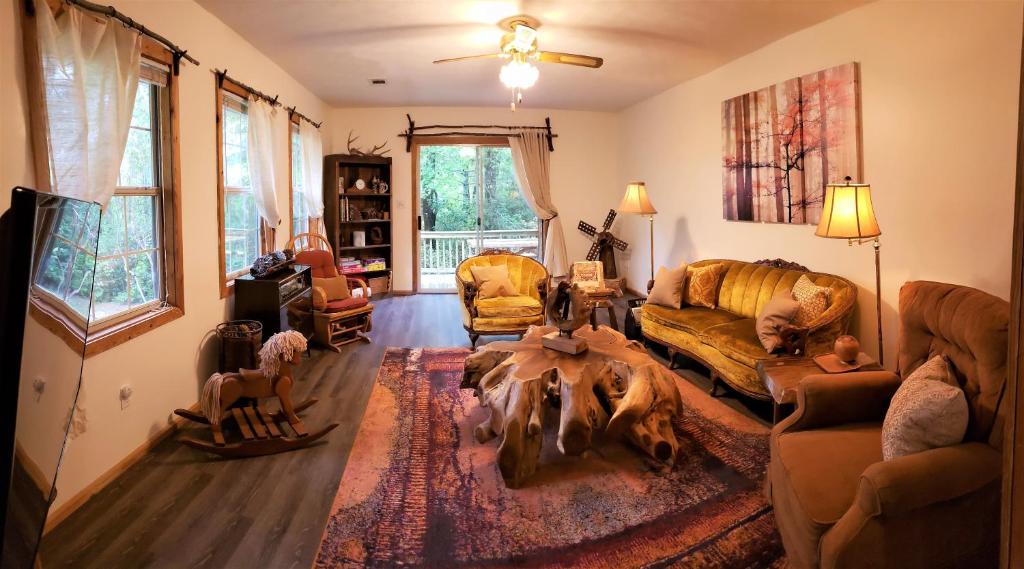 a living room with a couch and a table at Ridge Retreat at Hearthstone Cabins and Camping - Pet Friendly in Helen