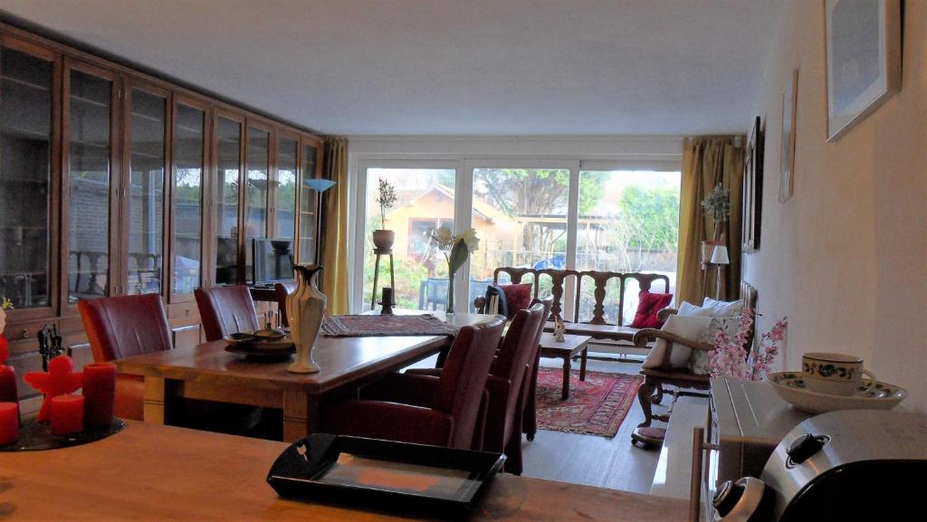a living room with a dining room table and chairs at Ambiance in Zierikzee