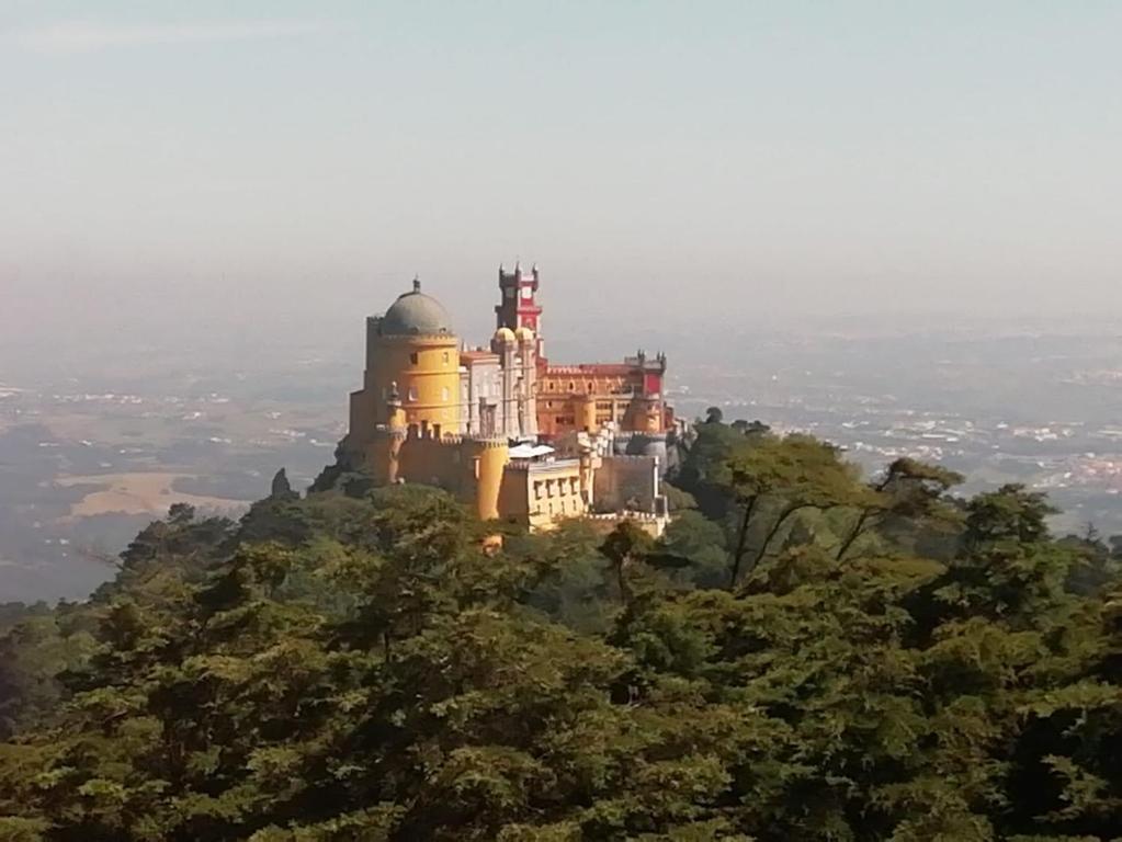 a castle on the top of a mountain at CasAzulApartments in Sintra