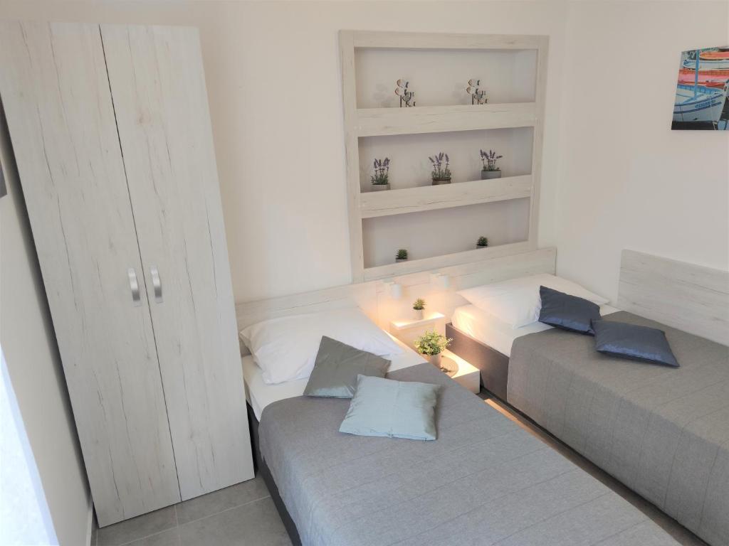 Postel nebo postele na pokoji v ubytování Apartments Rak