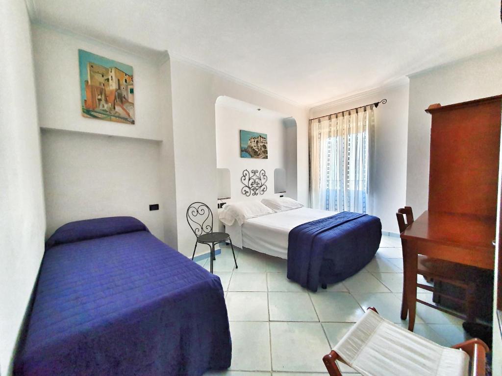 Postel nebo postele na pokoji v ubytování Hotel Corallo Sperlonga