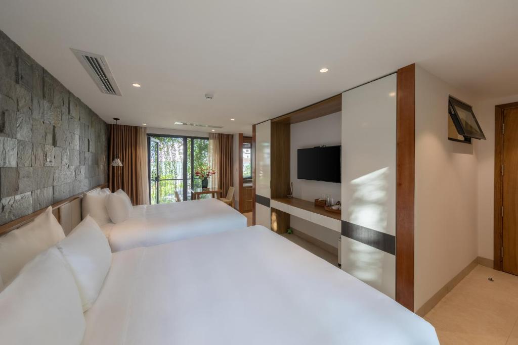 Giường trong phòng chung tại Ponte Boutique Da Nang