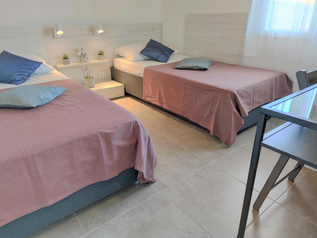 Postel nebo postele na pokoji v ubytování Apartments Rak