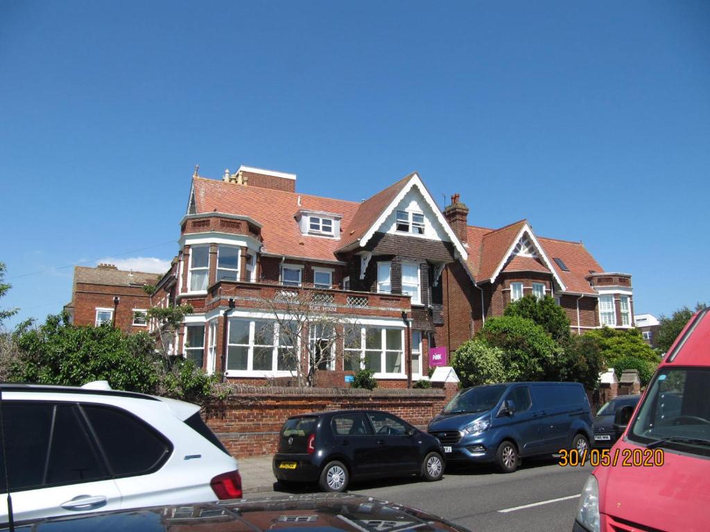 a large house with cars parked in front of it at Fort House in Portsmouth