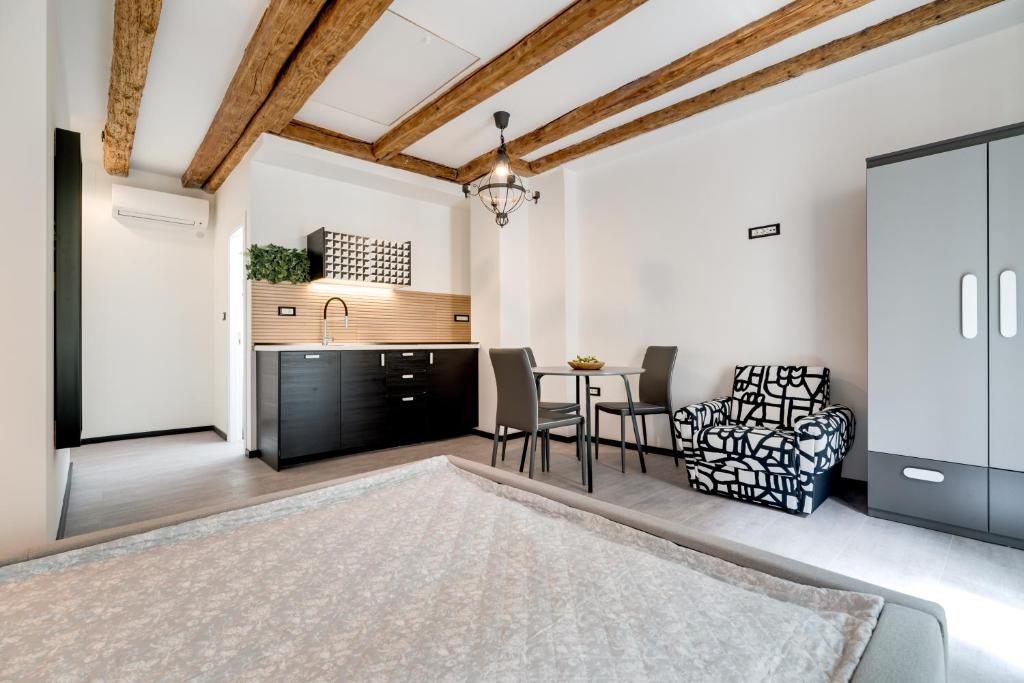 a kitchen and living room with a table and chairs at Black & White Apartments in Rijeka