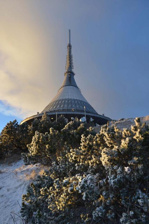 a building with a tower on top of a hill at Hotel Ještěd in Liberec