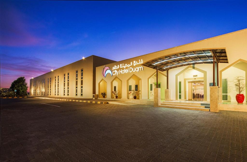 a large building with a sign on the front of it at City Hotel Duqm in Duqm