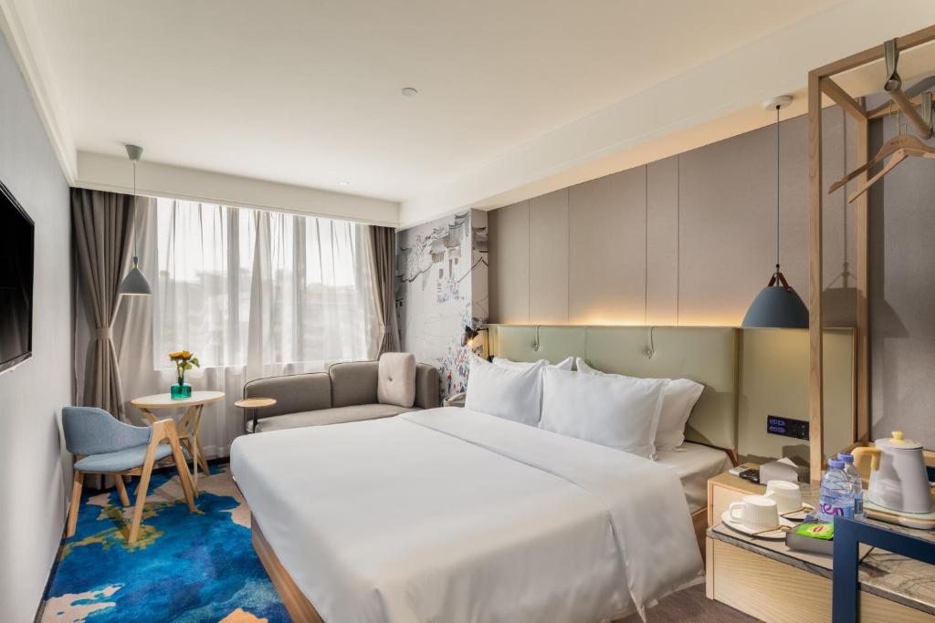 Postel nebo postele na pokoji v ubytování Shenzhen Yanan Hotel