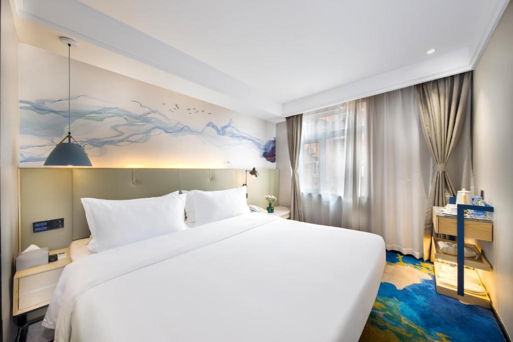 Postel nebo postele na pokoji v ubytování Shenzhen Yanan Hotel