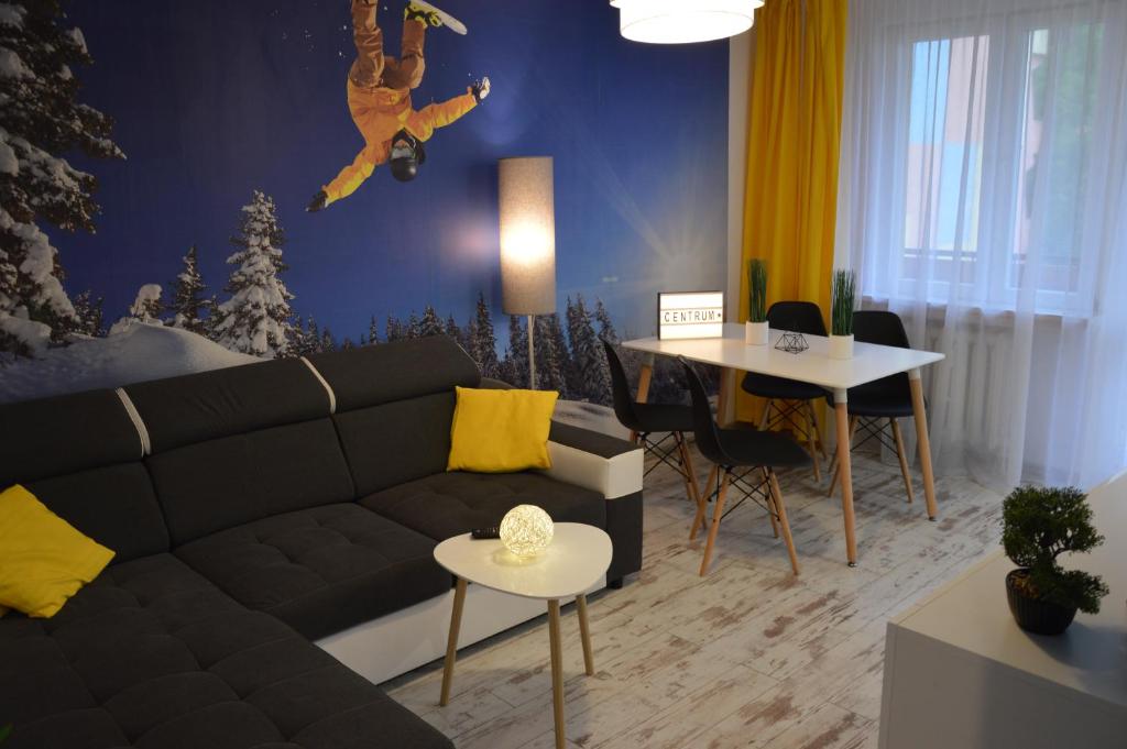 a living room with a couch and a table at Apartament Centrum in Szklarska Poręba