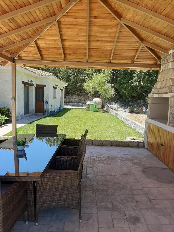a patio with a wooden pergola and a table and chairs at Lasa Valley Villa in Lasa