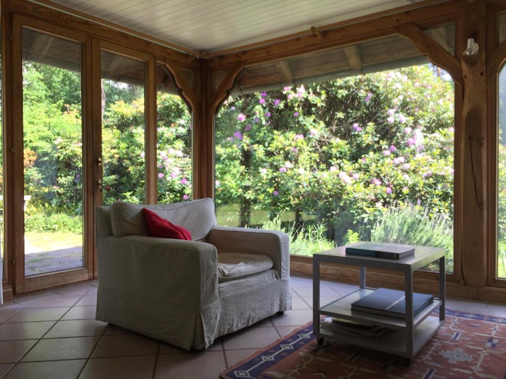 a screened in porch with a chair and a table at Hideaway in Hellwege