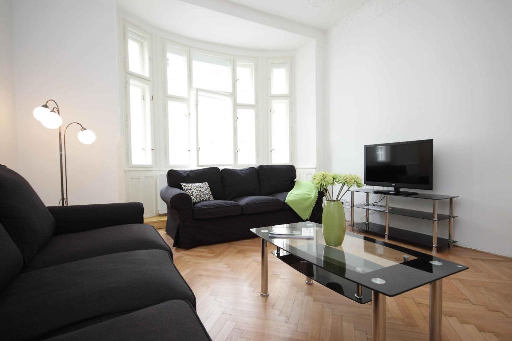 a living room with a couch and a coffee table at Prague Central Exclusive Apartments in Prague